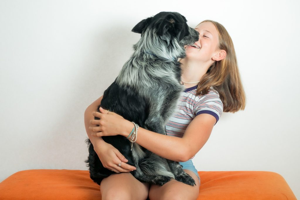 girl playing with a dog